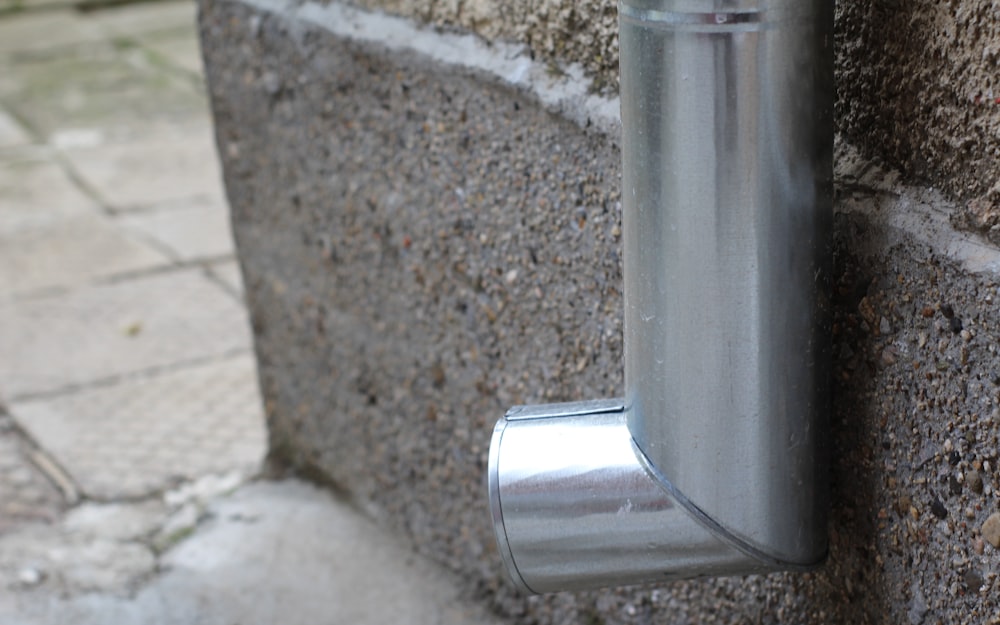 A metal gutter downspout on the exterior of a home.